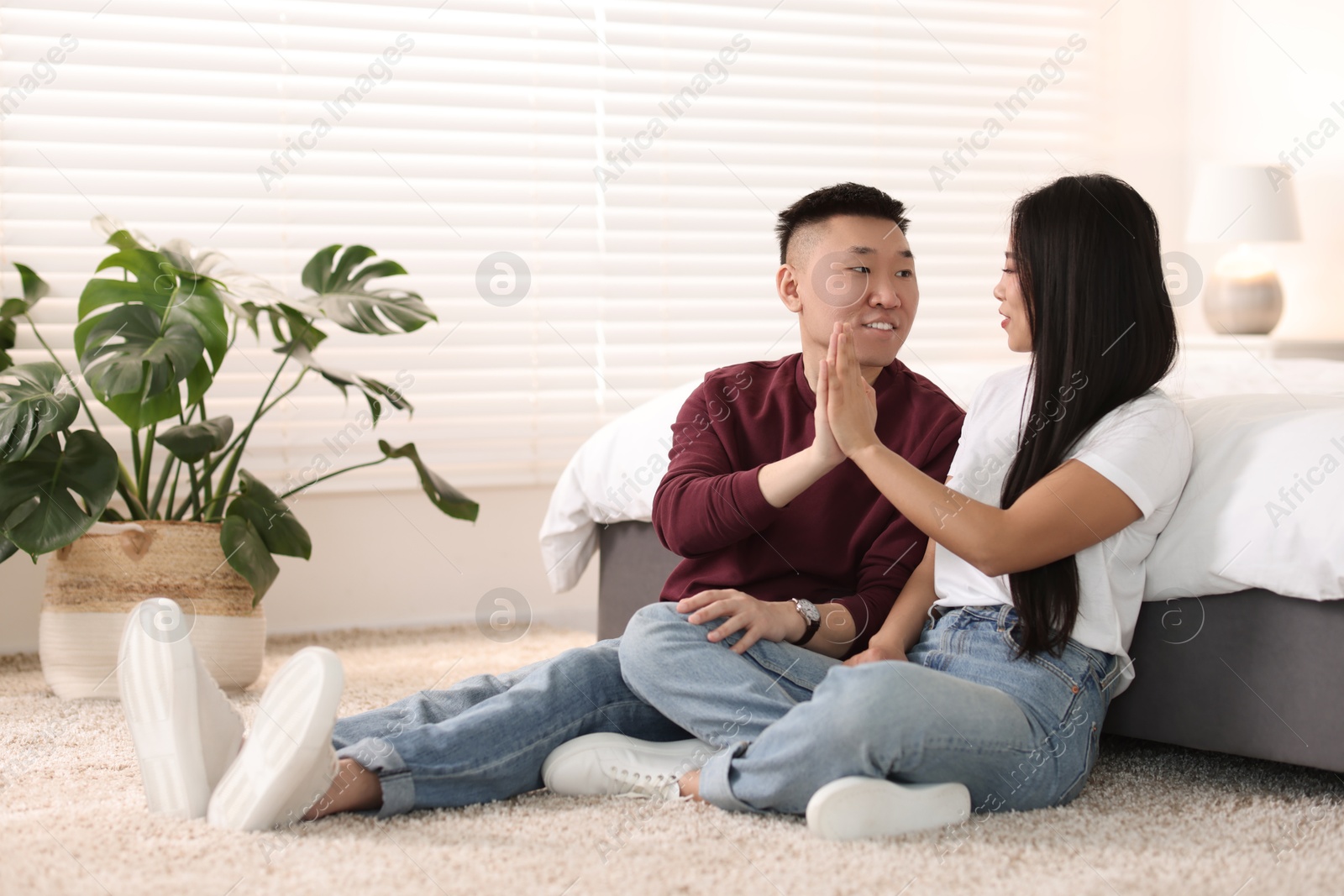 Photo of Lovely young couple on floor at home