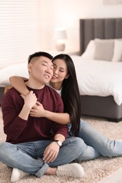 Photo of Lovely young couple on floor at home