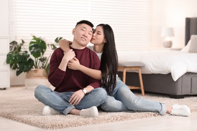 Lovely young couple on floor at home