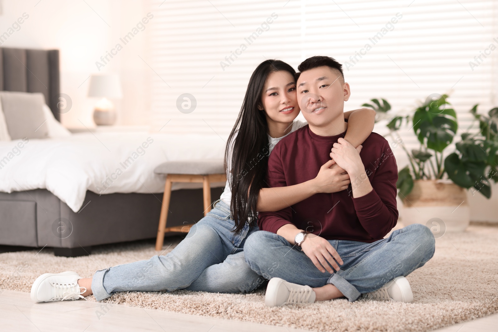 Photo of Lovely young couple on floor at home