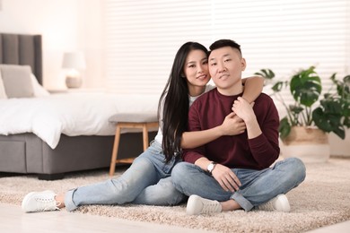 Photo of Lovely young couple on floor at home