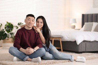 Photo of Lovely young couple on floor at home