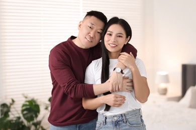 Photo of Portrait of lovely young couple at home