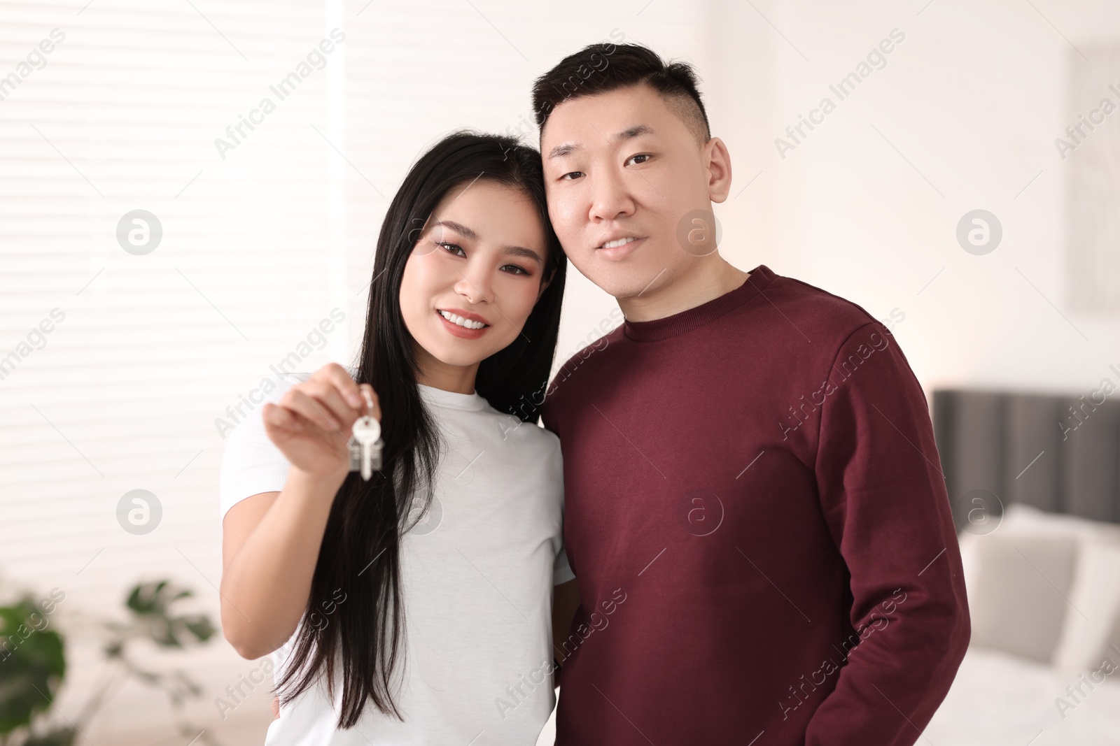 Photo of Happy couple with key in their new apartment