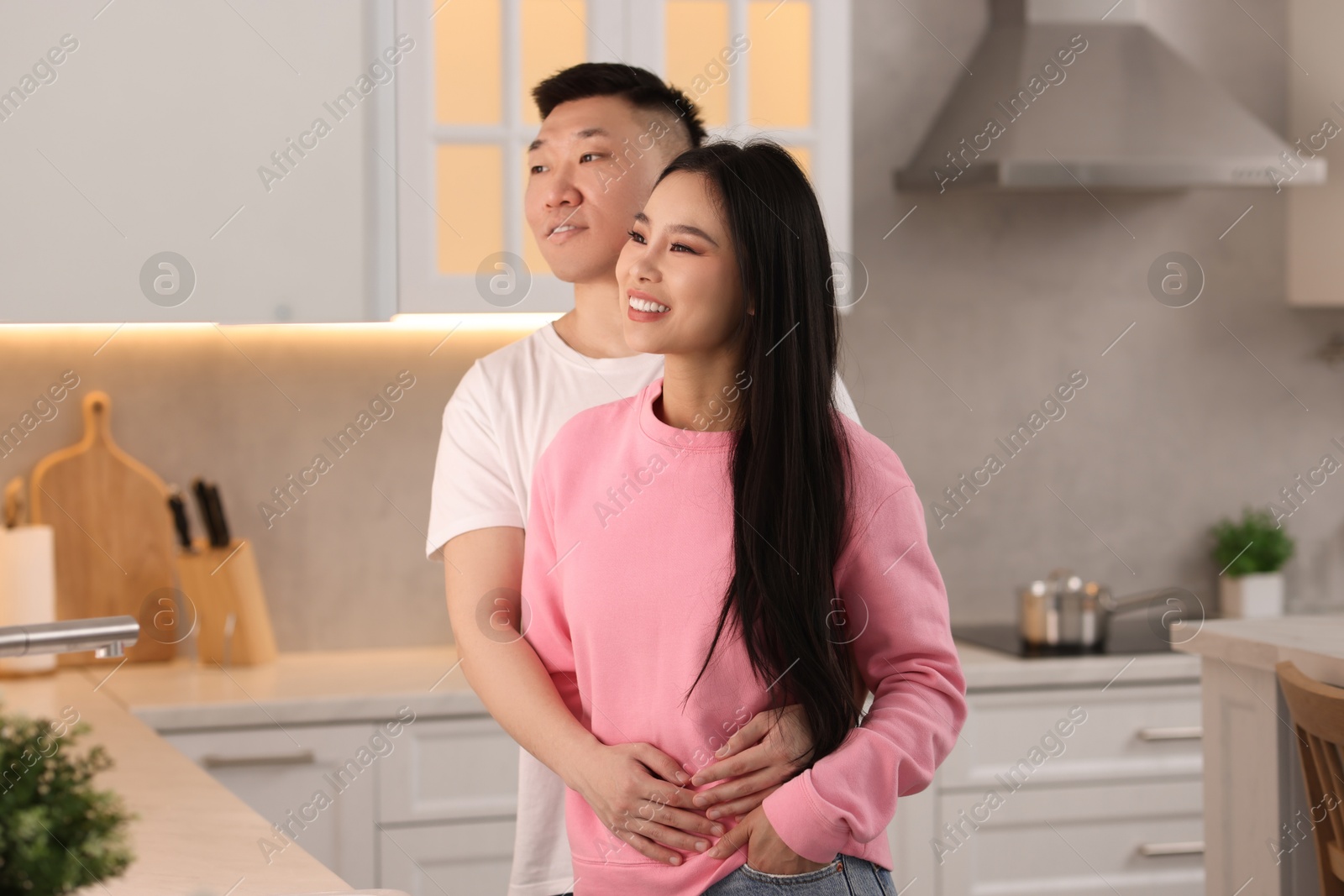 Photo of Portrait of lovely young couple in kitchen