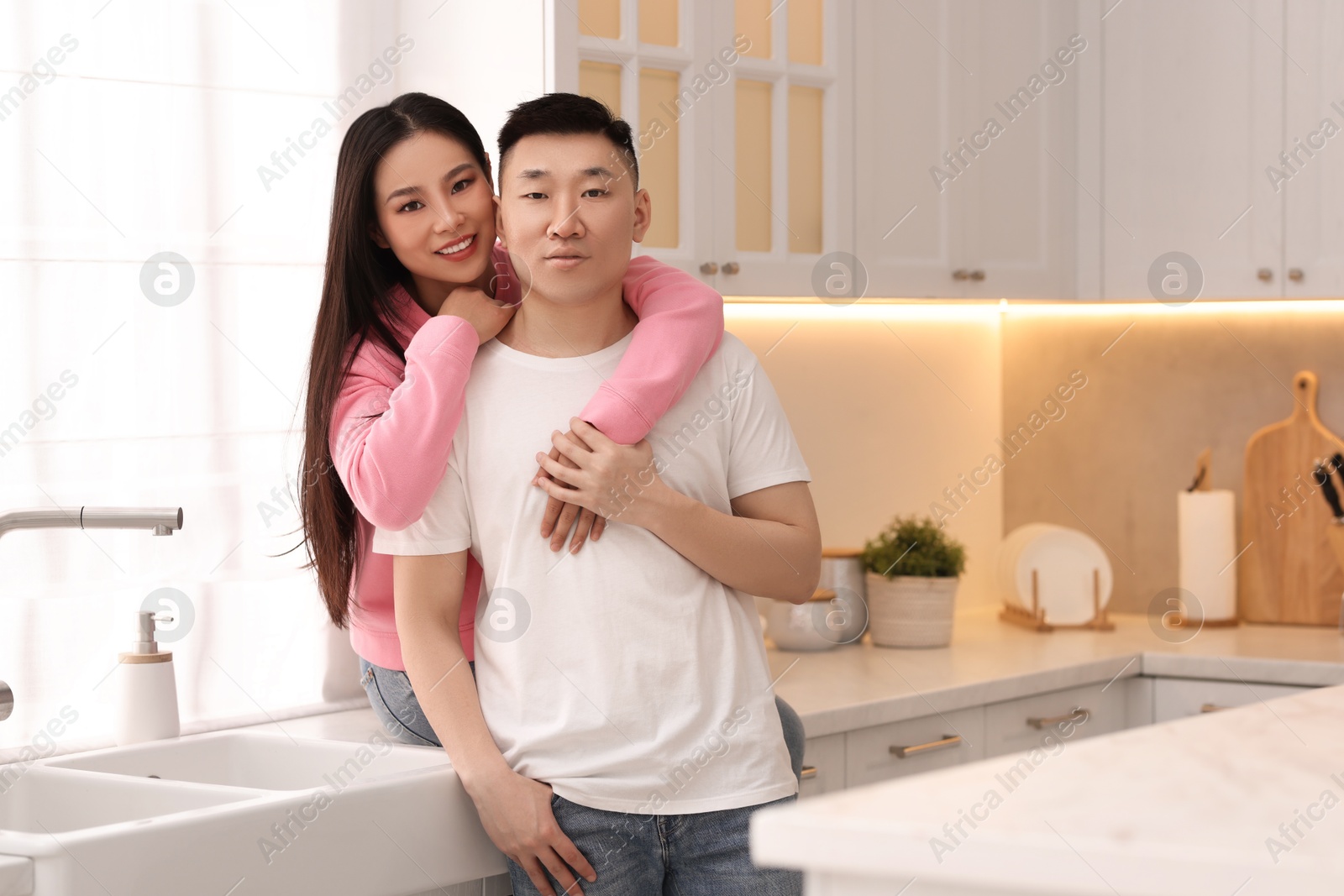 Photo of Portrait of lovely young couple in kitchen