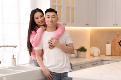 Portrait of lovely young couple in kitchen