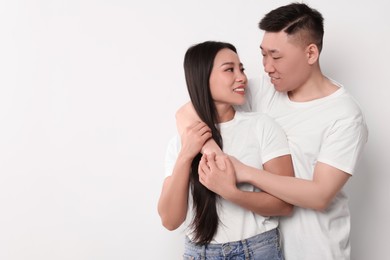 Portrait of happy couple on white background, space for text