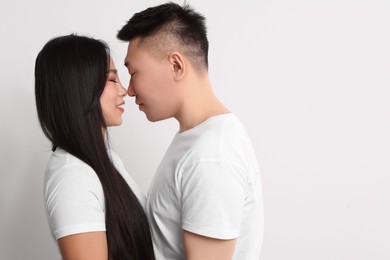 Portrait of happy couple on white background, space for text