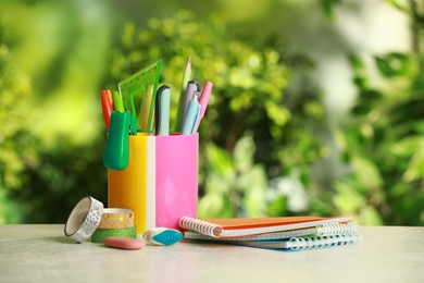 Stapler, notebooks, holder and other different stationery on white table