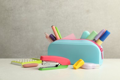 Photo of Stapler, pencil case and other different stationery on white table