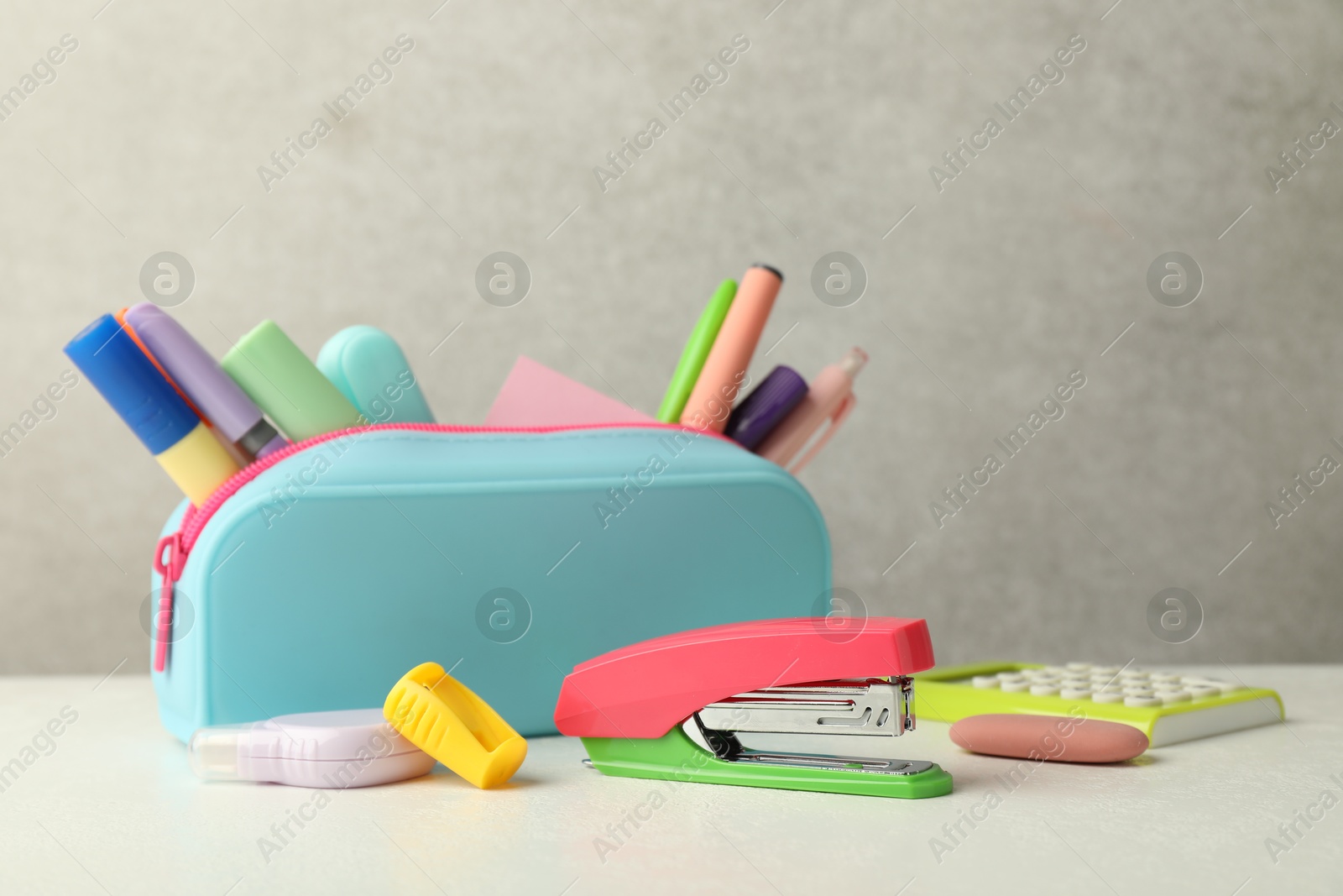 Photo of Stapler, pencil case and other different stationery on white table