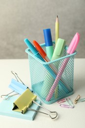 Photo of Holder and other different stationery on white table