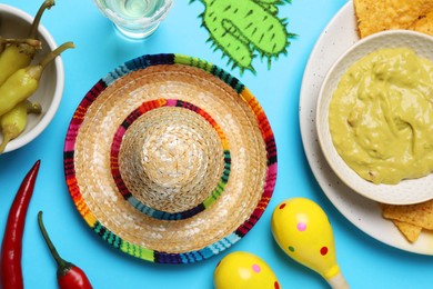 Flat lay composition with Mexican sombrero hat on light blue background