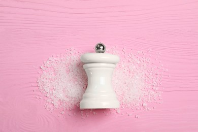 Photo of Salt shaker on pink wooden table, top view