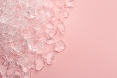 Pieces of crushed ice on pink background, top view. Space for text