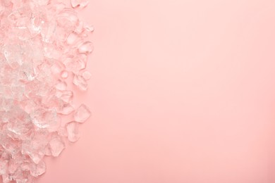 Photo of Pieces of crushed ice on pink background, top view. Space for text