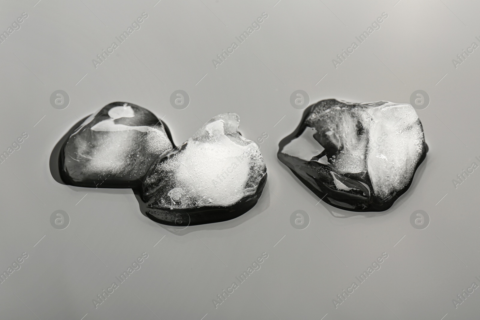 Photo of Pieces of crushed ice on grey background