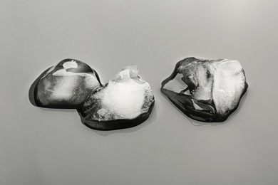 Pieces of crushed ice on grey background