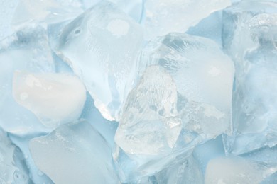 Photo of Pieces of crushed ice on light blue background
