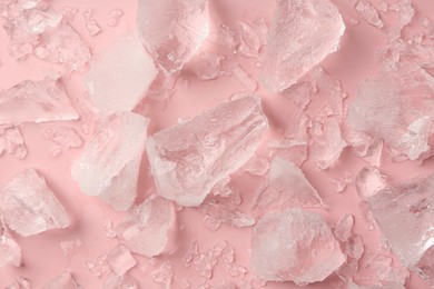 Photo of Pieces of crushed ice on pink background, top view