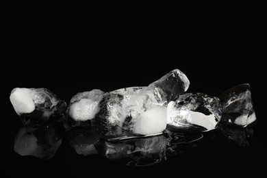 Photo of Pile of crushed ice on black mirror surface