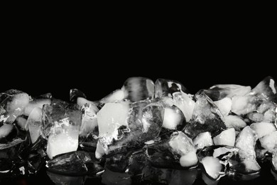 Photo of Pile of crushed ice on black mirror surface