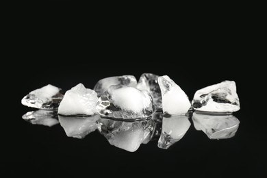 Photo of Pile of crushed ice on black mirror surface