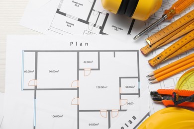 Flat lay composition with building level and other construction tools on white wooden table