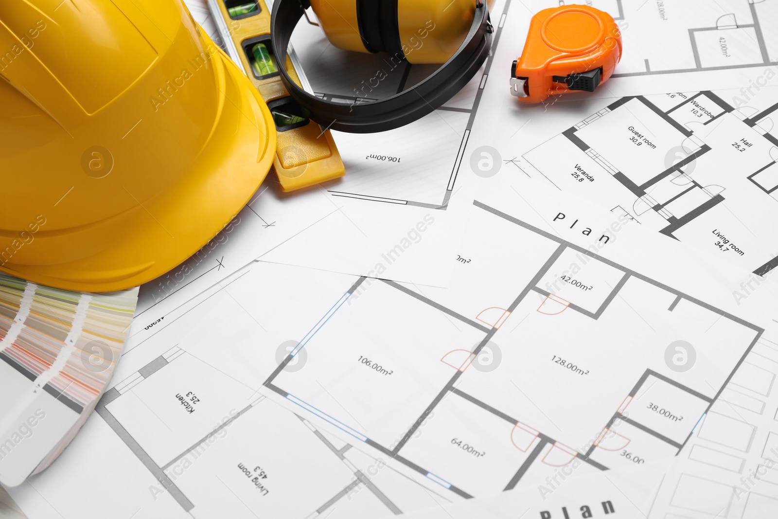 Photo of Building level and other construction tools on papers