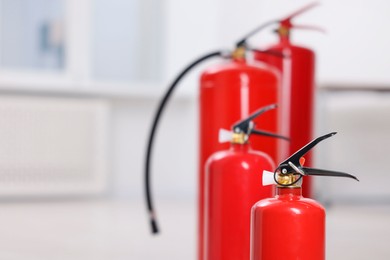 Photo of Fire extinguishers indoors, closeup. Space for text