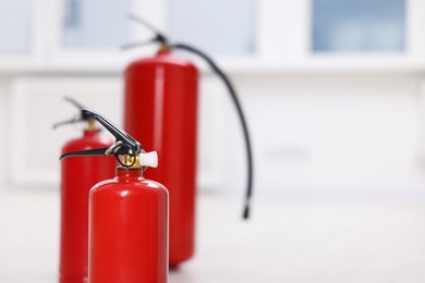 Photo of Fire extinguisher indoors, closeup. Space for text