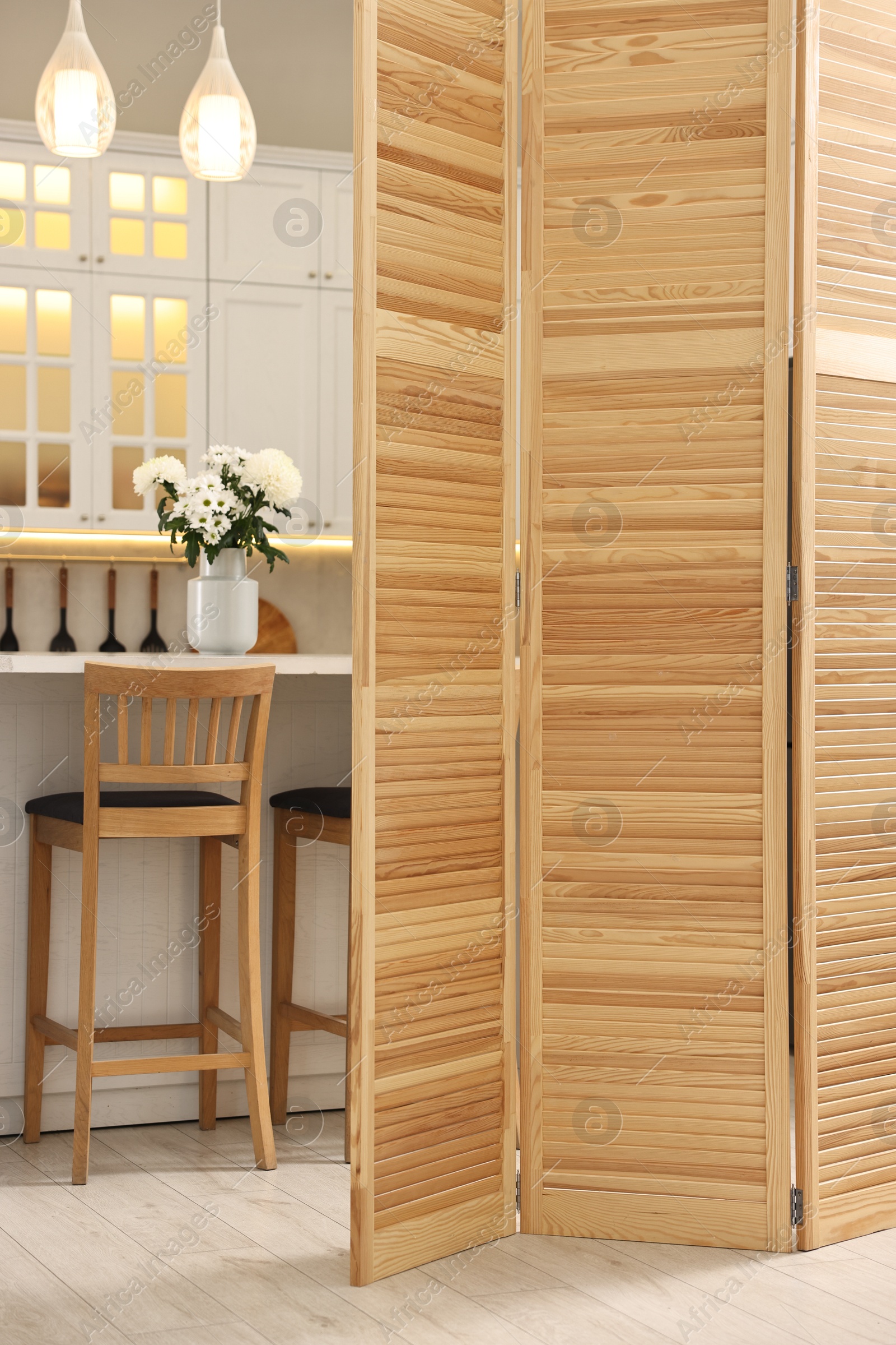 Photo of Stylish kitchen interior with folding screen and table