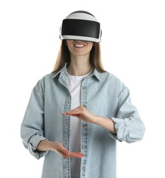 Photo of Smiling woman using virtual reality headset on white background