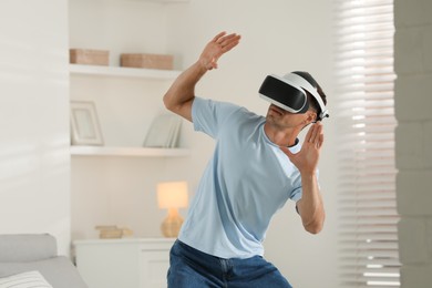 Man using virtual reality headset at home