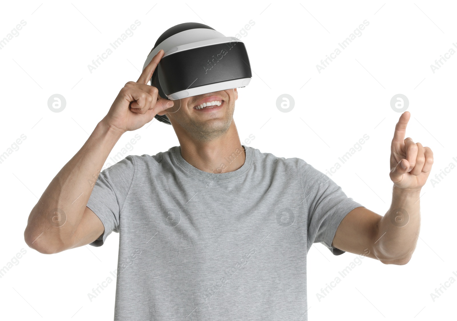 Photo of Smiling man using virtual reality headset on white background