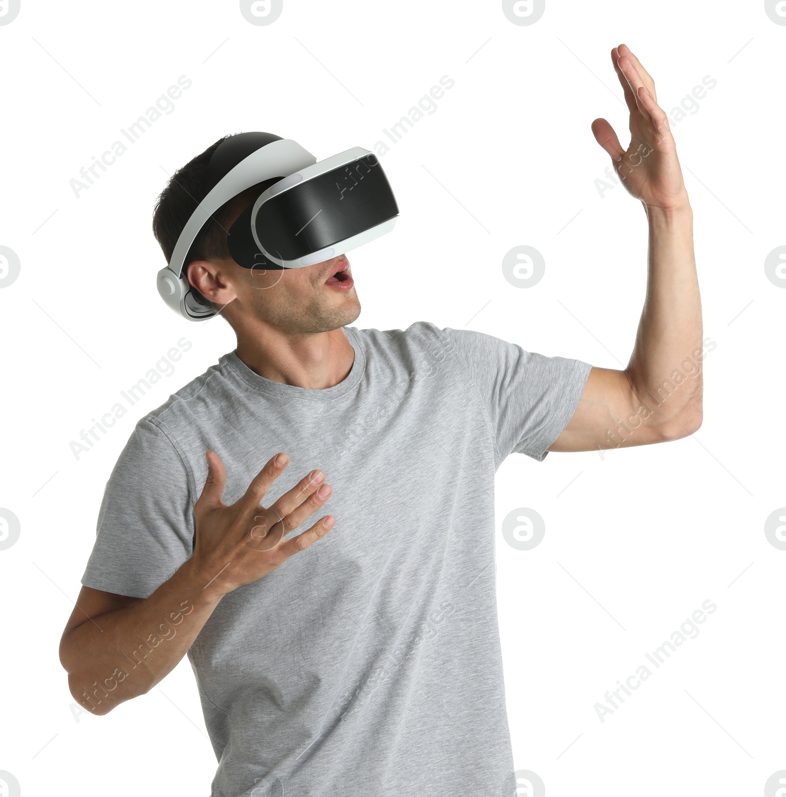 Photo of Surprised man using virtual reality headset on white background