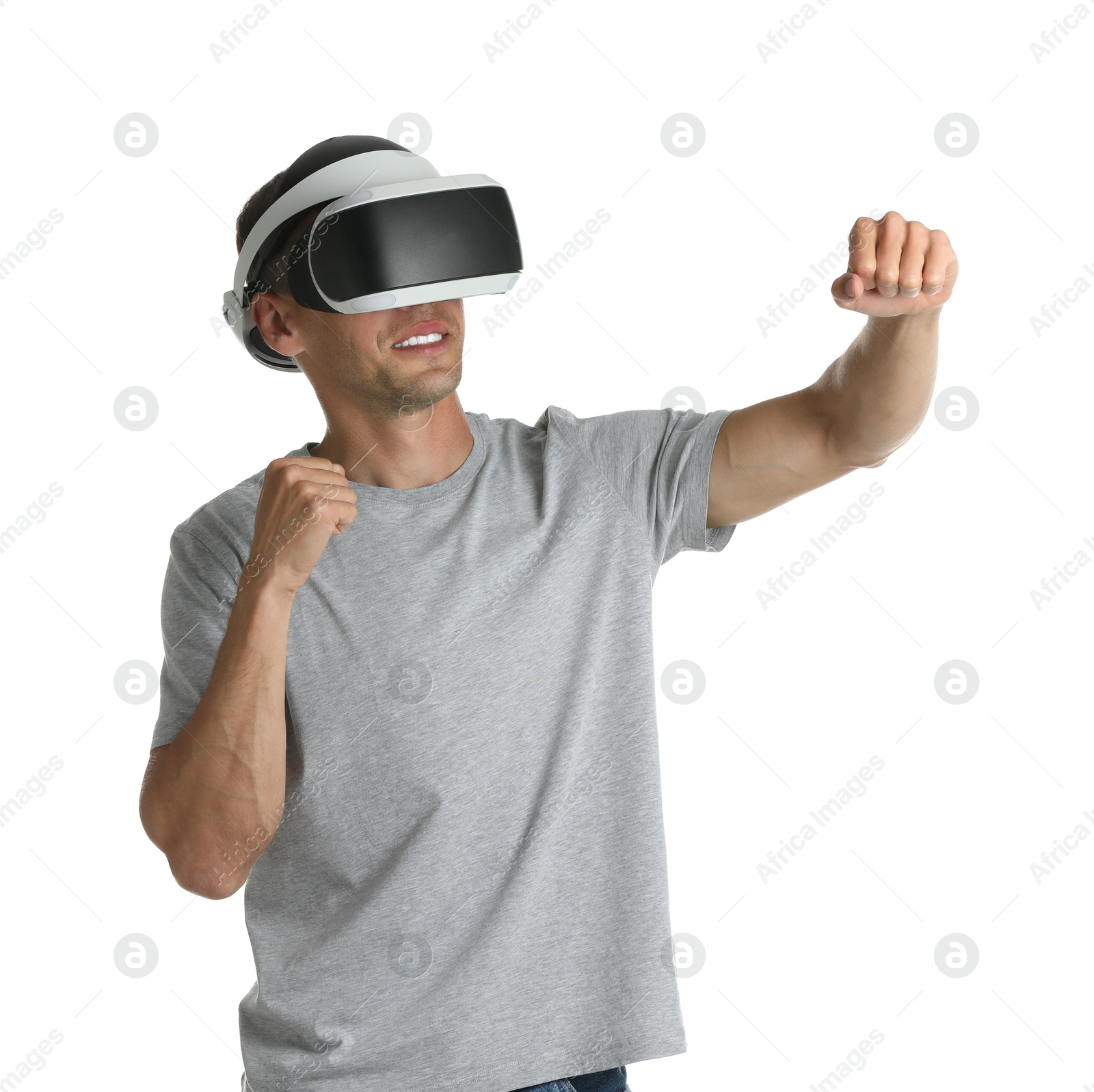 Photo of Smiling man using virtual reality headset on white background