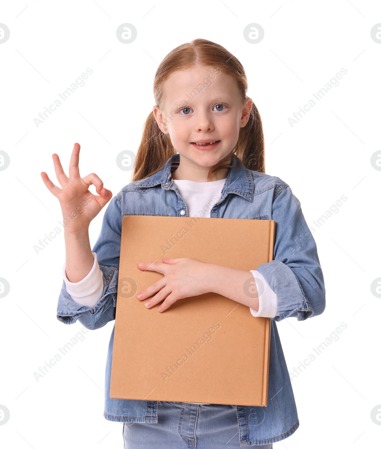 Photo of Smiling girl with book showing ok gesture on white background