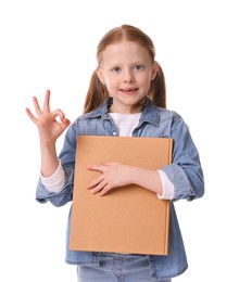 Photo of Smiling girl with book showing ok gesture on white background