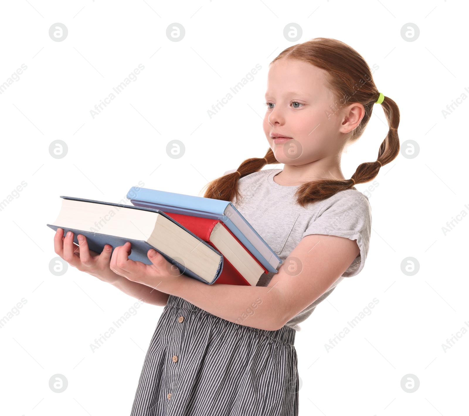 Photo of Cute little girl with stack of books on white background