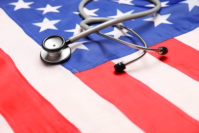 Photo of Stethoscope on USA flag, closeup. Health care concept