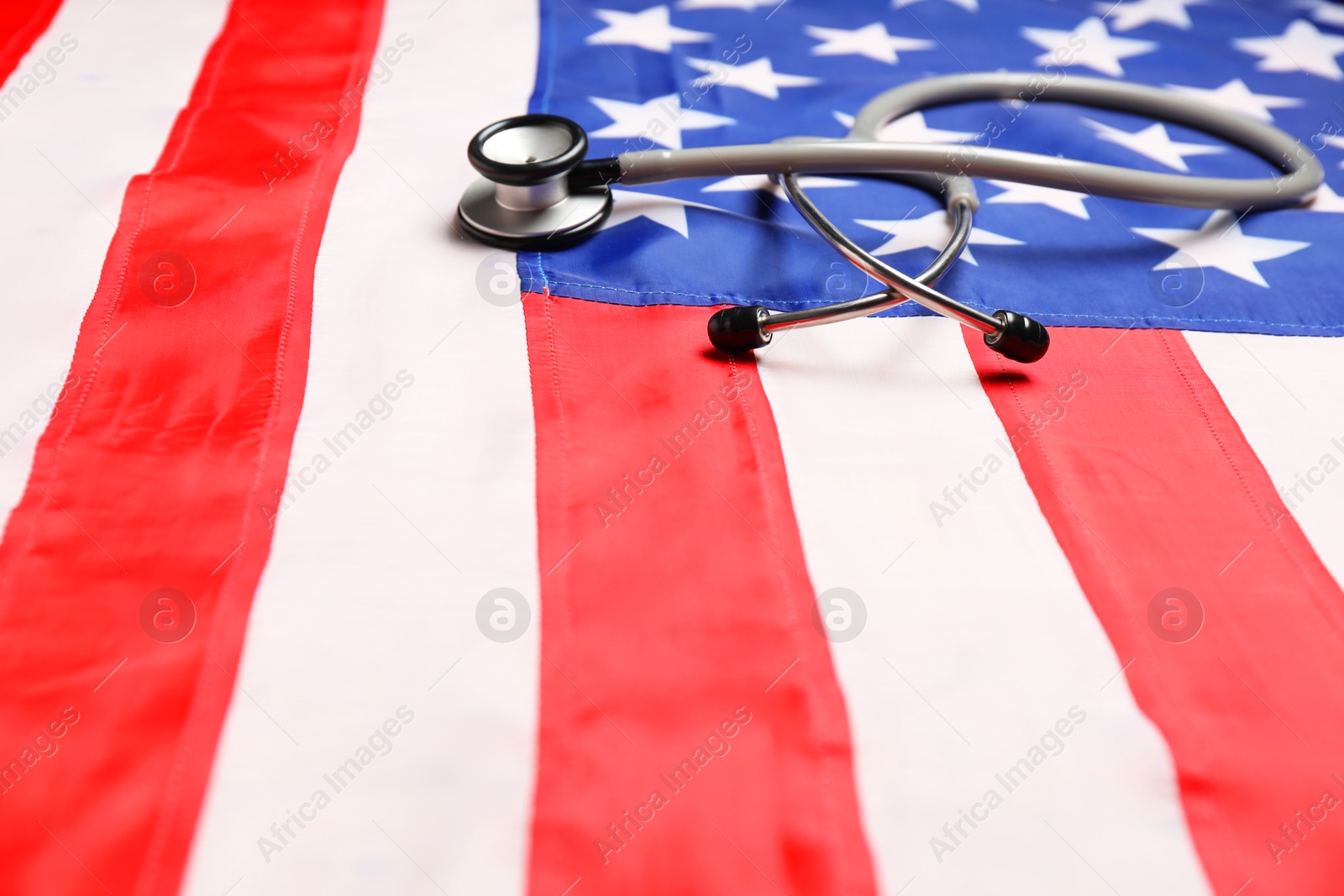 Photo of Stethoscope on USA flag, closeup. Health care concept