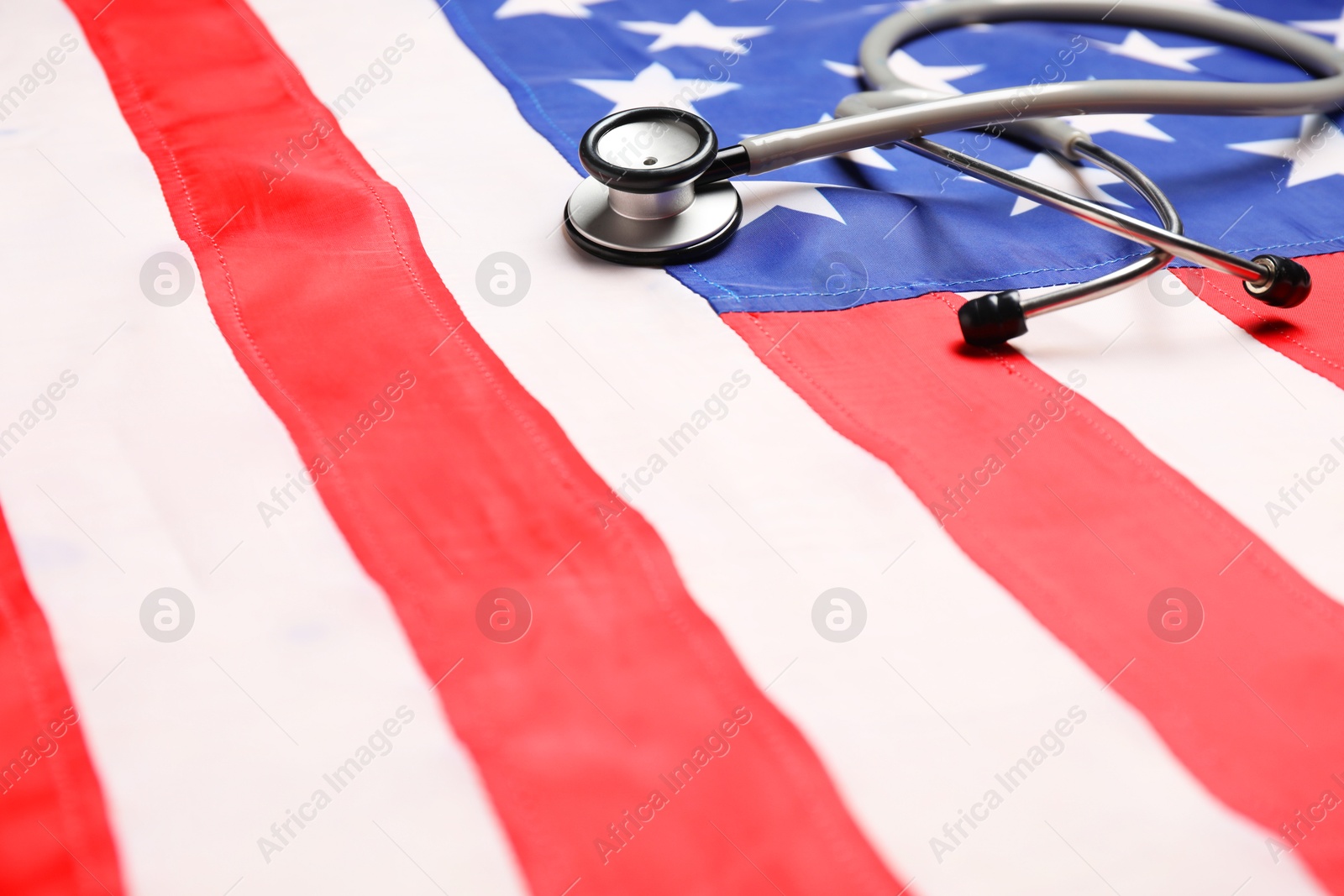 Photo of Stethoscope on USA flag, closeup. Health care concept