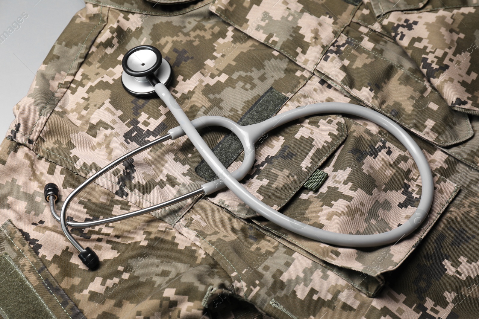 Photo of Stethoscope and military uniform on white table