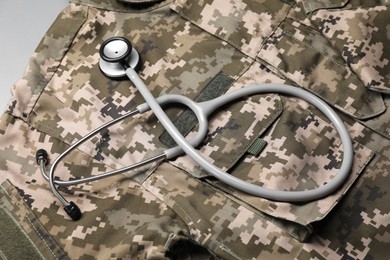 Stethoscope and military uniform on white table