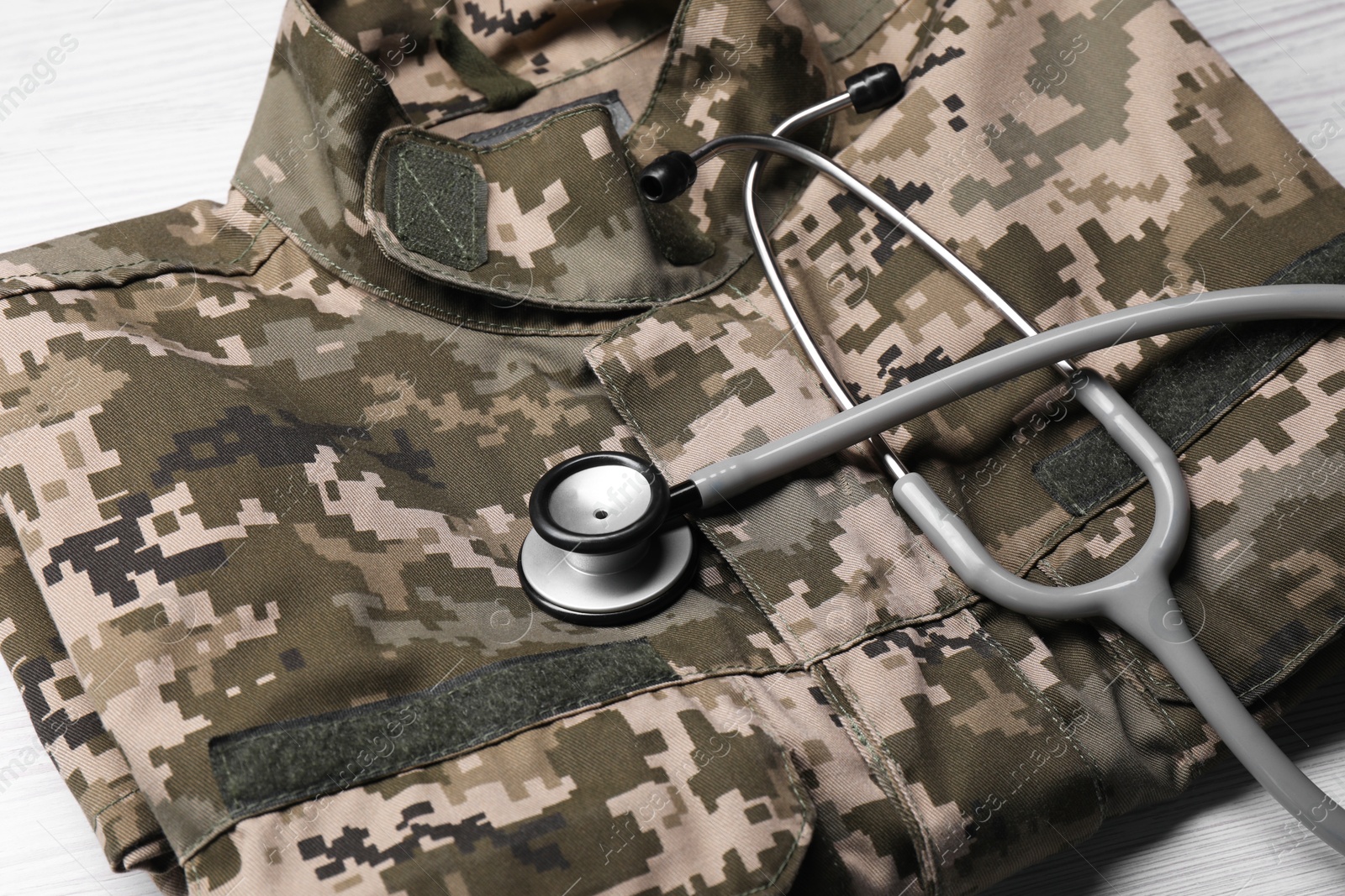 Photo of Stethoscope and military uniform on white table