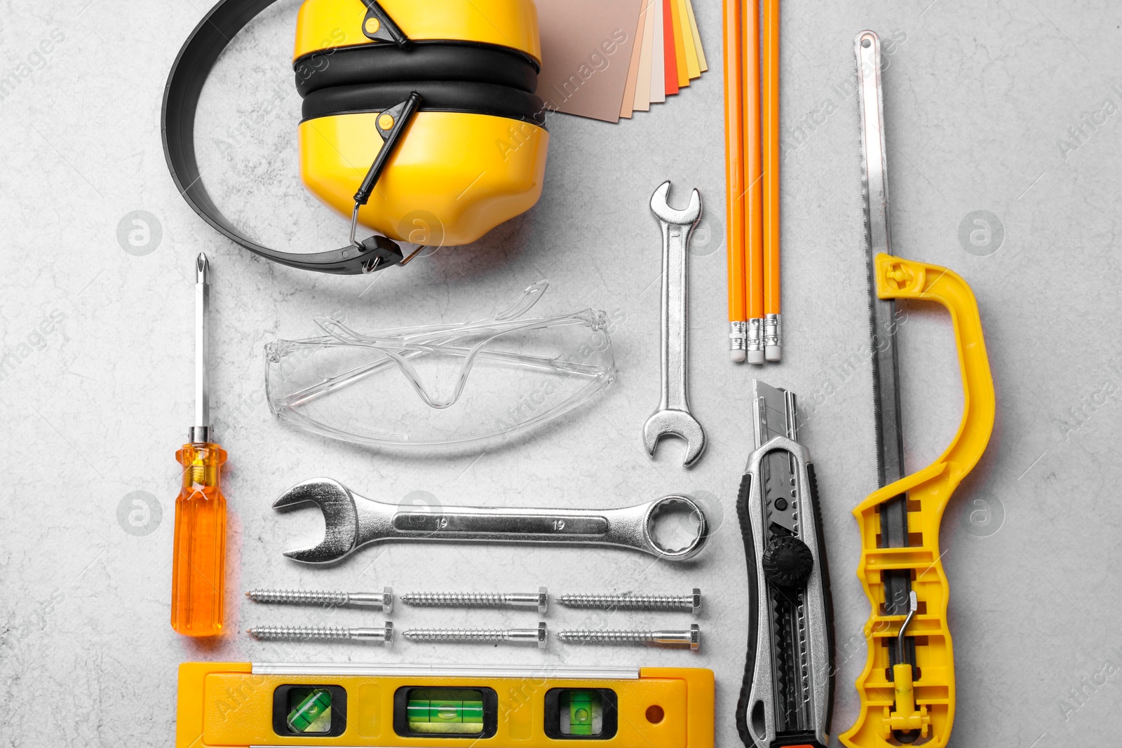 Photo of Flat lay composition with building level and other construction tools on grey table