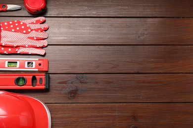 Photo of Flat lay composition with building level and other construction tools on wooden table, space for text