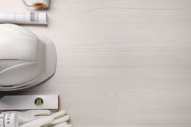 Photo of Flat lay composition with building level and other construction tools on white wooden table, space for text